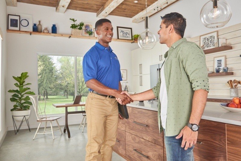 Home-service professional greeting a homeowner after a service visit