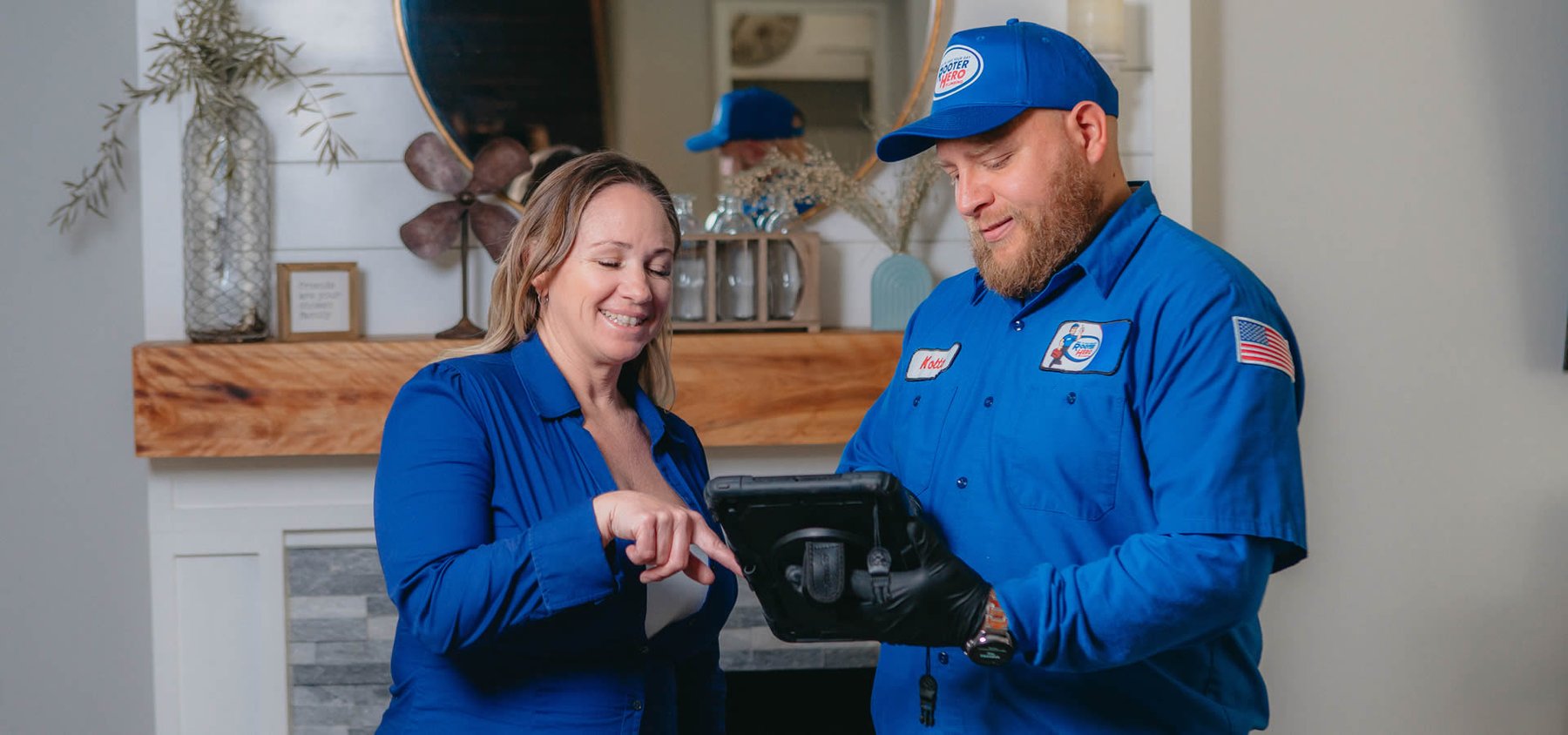 Home-service technician reviewing service information with a customer